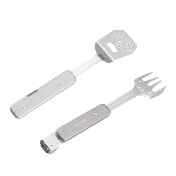 Two silver metal multitools are shown on a white background, one with a spatula head and the other with a fork head, both with the brand name ROXON visible on the handle.