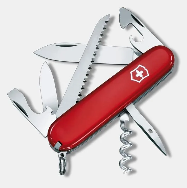 A red Victorinox Swiss Army knife with multiple tools deployed, including a large blade, a saw, a corkscrew, and a bottle opener.