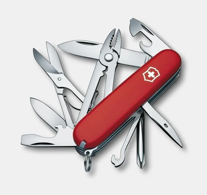 A red Victorinox Swiss Army knife with its tools fanned out, including pliers, scissors, and a hammer head.