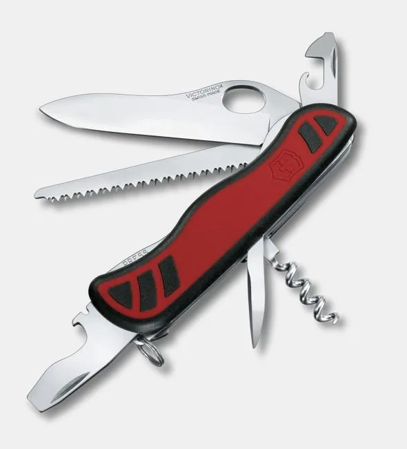 A Victorinox Forester M Grip pocket knife with red and black handles is shown with its main blade, saw, corkscrew, and other tools deployed.