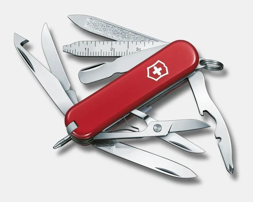 A red Victorinox Swiss Army knife with its tools fanned out, including a blade, scissors, ruler, and file.